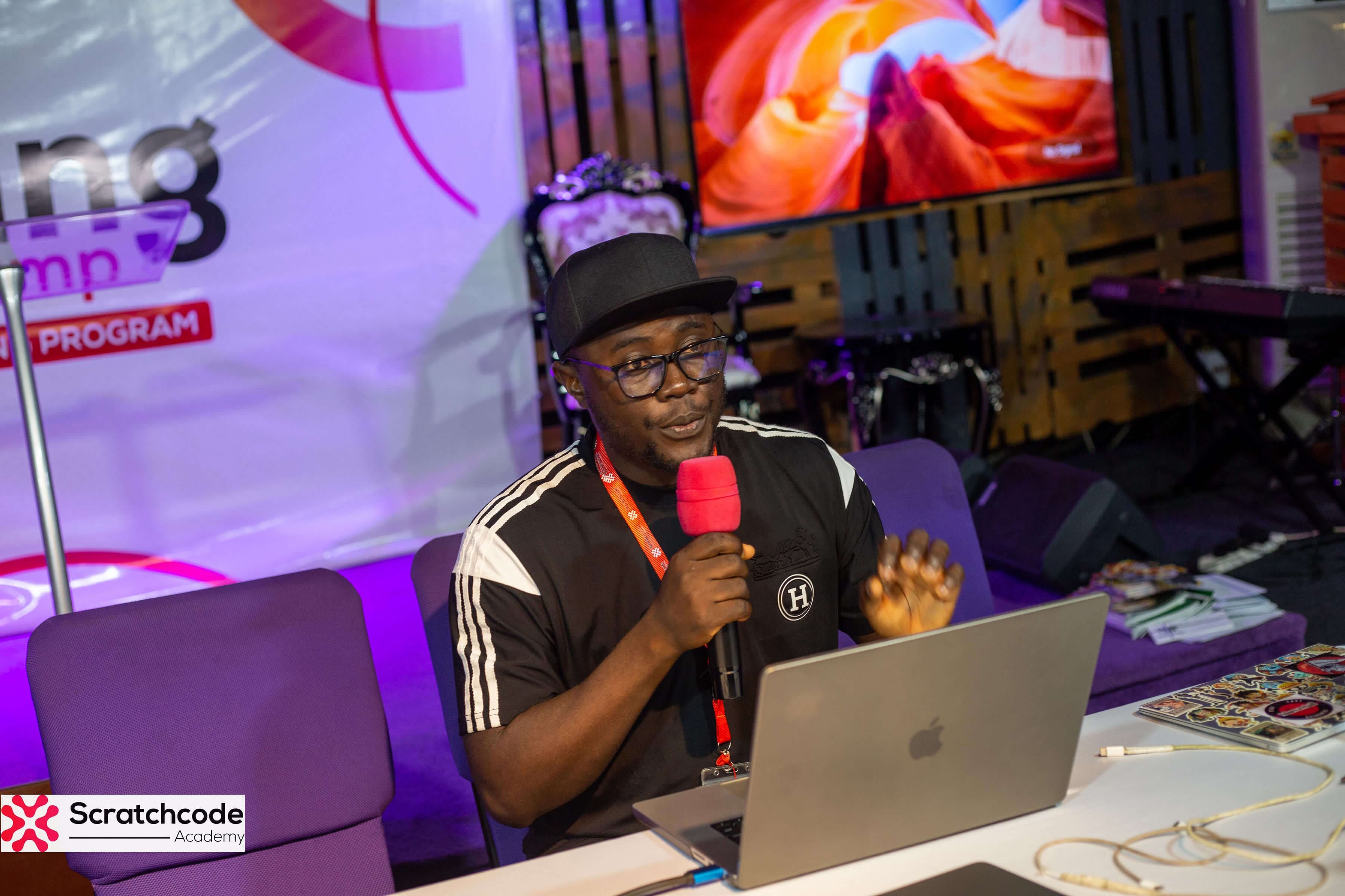 Augustine speaking at a bootcamp session